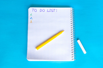 Words To do list written in open notebook on the blue background.
