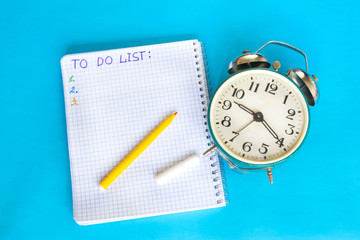 Words To do list written in open notebook on the blue background.
