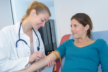 Nurse finding vein to take blood