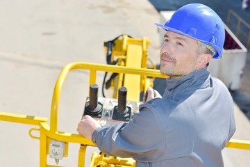 man controlling a yellow colored machine