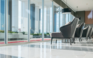 Row of chairs in executive office waiting room. background outdoor modern lobby big window and blue...