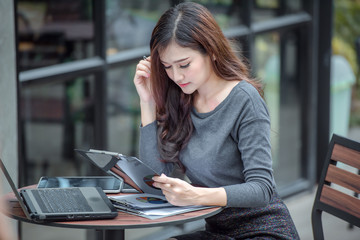 Young attractive Asian business woman sleeping, drowsing or taking a nap at her desk, Tired...