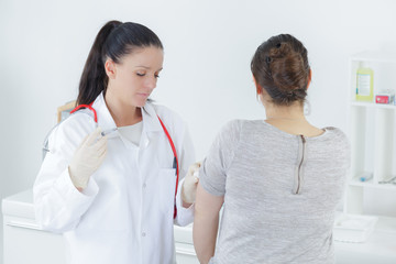 doctor examining her patients stomach in medical office