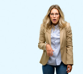 Young beautiful woman scared in shock, expressing panic and fear