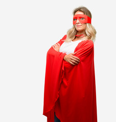 Young super hero woman wearing cape with crossed arms confident and happy with a big natural smile laughing
