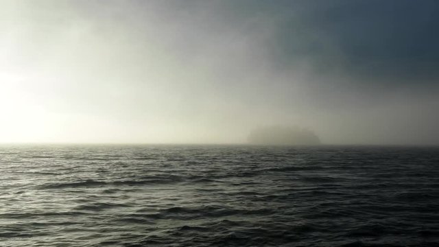 Huge lake Onega in Western Russia. Beautiful little forest Island in haze.
