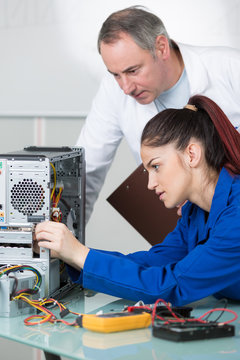 young female fixing a computer