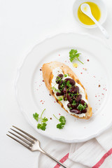 Sandwich with red beans, garlic, olive oil and curd cheese on white background. Mexican Cuisine. Top view.