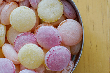 Beautiful colorful lollipops close-up. Chocolate nut in a tin box. Yellow, orange, red, purple, pink, bright candy in the jar. A vintage treat for the children. Decoration for dessert table.