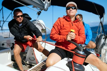 Stoff pro Meter Attractive strong woman sailing with her boat © NDABCREATIVITY