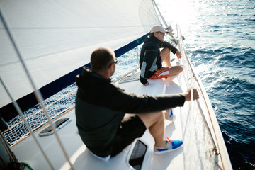 Handsome strong men sailing with their boat