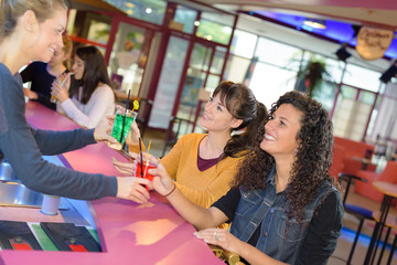 friends being served drinks in hotel bar