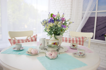 Table setting. Tea drinking. Interior in light colors. Feast
