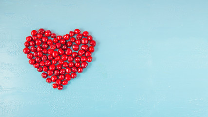 Berries of strawberries and cherries on a blue background. Concept banners and postcards Copy space Top view