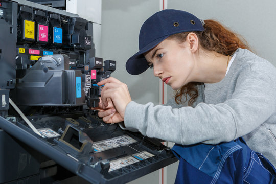 Female technician working on electrical appliance