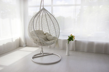 White interior. White hanging chair. Cocoon chair