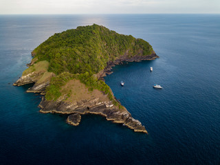 Aerial drone view of tropical Koh Bon island with several dive boats in the bay