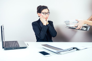 attractive smart brunette woman (business lady) in stylish business suit and glasses working with...