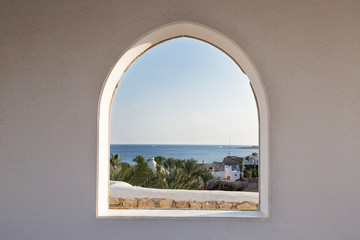 Egypt. A look through the frame on the palm trees. Beautiful view. White house and veranda...