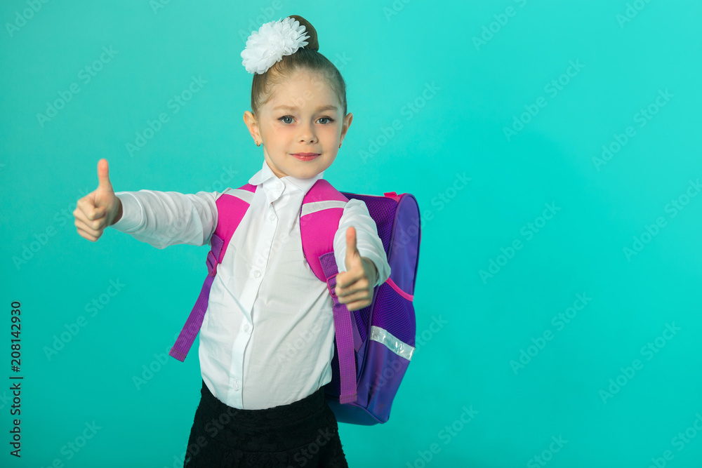 Wall mural beautiful little happy girl in white shirt with bow on head and with briefcase on blue background