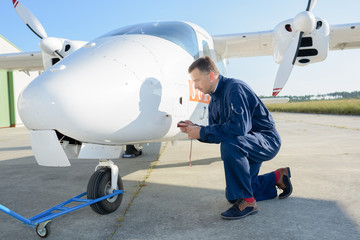 man fixing an airplane