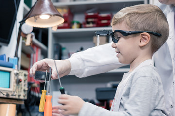 Physics experiment with magnet and work tools.