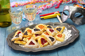 homemade hamantaschen cookies,noise maker and mask, for happy Purim jewish holiday party
