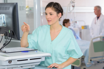 Nurse reading computer screen