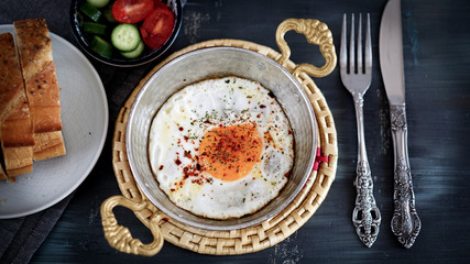 fried egg in the copper frying pan