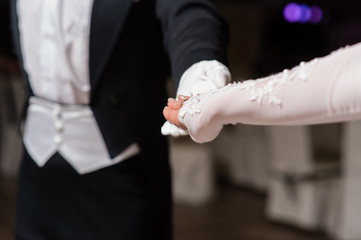 Couple hands dancing waltz at ball