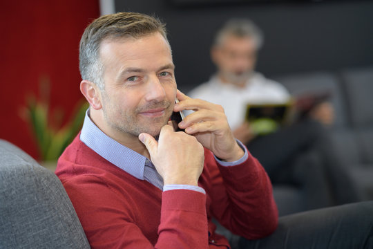 Man Making Call In First Class Lounge