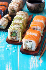 Sushi set and chopstiks on wooden blue backgound