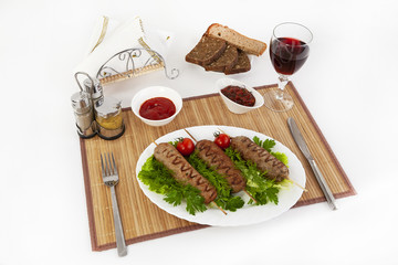 Lula kebab with tomatoes and cucumbers. Serve with black or white bread and a glass of red wine.