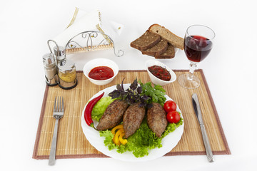 Cutlets with greens, tomatoes and cucumbers. Serve with black or white bread and a glass of red wine.