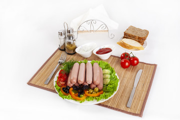 Boiled sausages with tomatoes, cucumbers and greens. Served with black or white bread.