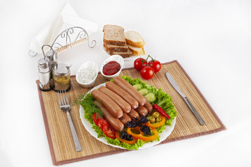 Boiled sausages with tomatoes, cucumbers and greens. Served with black or white bread.