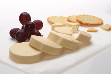 Slices of cheese next to some grapes