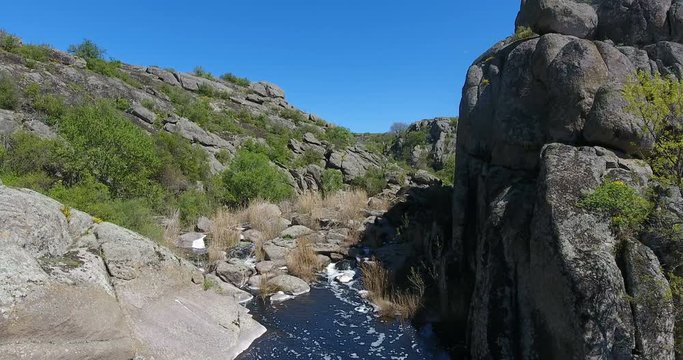 Aerial view. Group of tourists deep canyon among the rocks. Mountain landscape