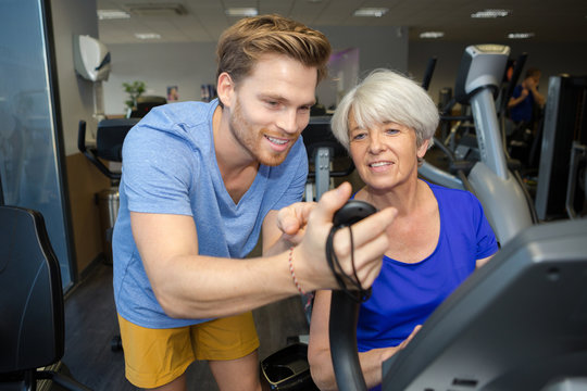senior woman working out with personal trainer