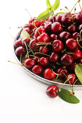 Cherry. Red fresh Cherries in bowl and a bunch of cherries on the table
