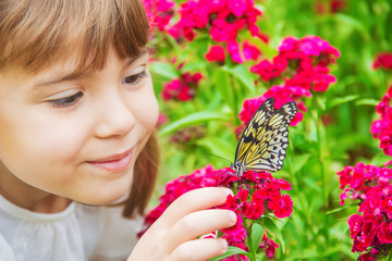 Child with a butterfly. Idea leuconoe. Selective focus. © yanadjan