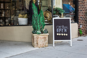 Open sign in front of shop entrance