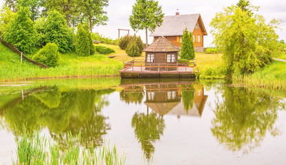 Small wooden house on the lake shore