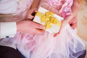 Closeup of men's and children's hands holding New Year gift