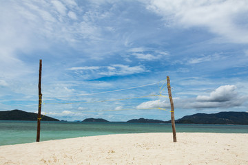 Fototapeta na wymiar Volleyball net on wooden stands on a tropical sandy beach in Koh Samui, Thailand