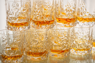 Many Glasses with whiskey at a buffet table