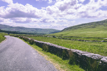 Fototapeta na wymiar The scenic road of Healy Pass, a 12 km route worth of hairpin turns winding through the borderlands of County Cork and County Kerry in Ireland