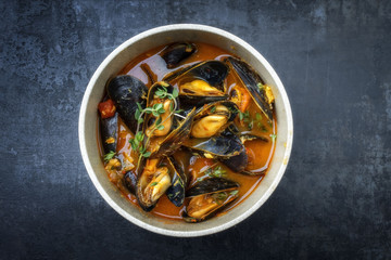 Traditional French Corsican mussel stew with mussels as top view in a pot with copy space