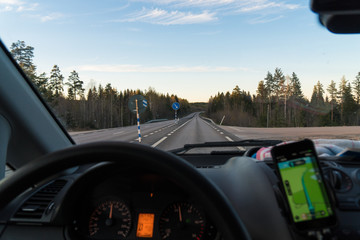 Driving a car alone on a road (European route E4) in Sweden
