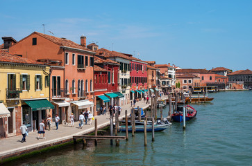 Island Murano in Venice Italy. View on canal with boat and motorboat water. Picturesque landscape. Traditional view of The Venetian canals